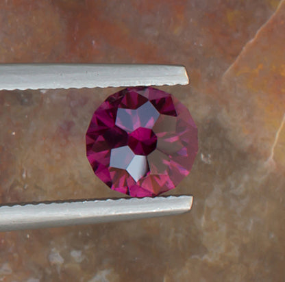 2.21ct Umbalite Garnet Colored Gemstone Top View Natural Background 
