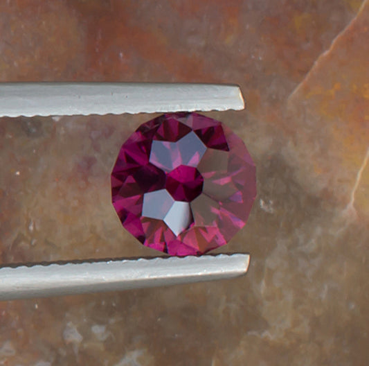 2.21ct Umbalite Garnet Colored Gemstone Top View Natural Background 
