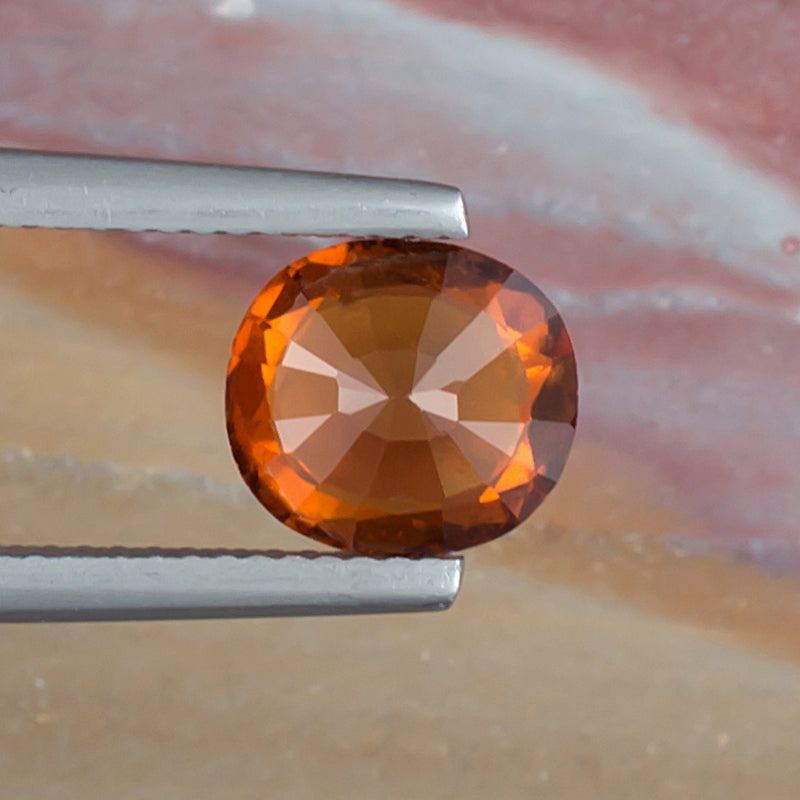 2.36ct Hessonite Garnet Colored Gemstone Bottom View Natural Background 
