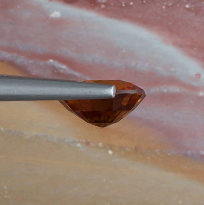 2.36ct Hessonite Garnet Colored Gemstone Side View Natural Background 
