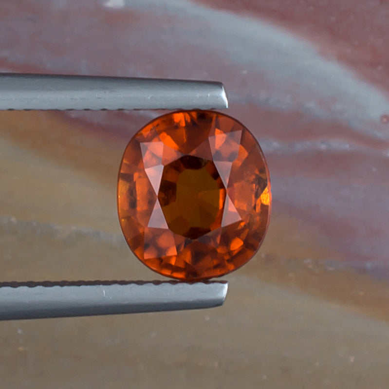 2.36ct Hessonite Garnet Colored Gemstone Top View Natural Background 
