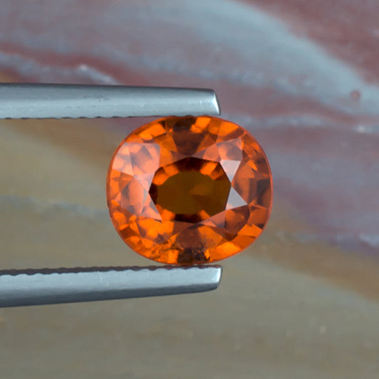 2.36ct Hessonite Garnet Colored Gemstone Top View Natural Background 
