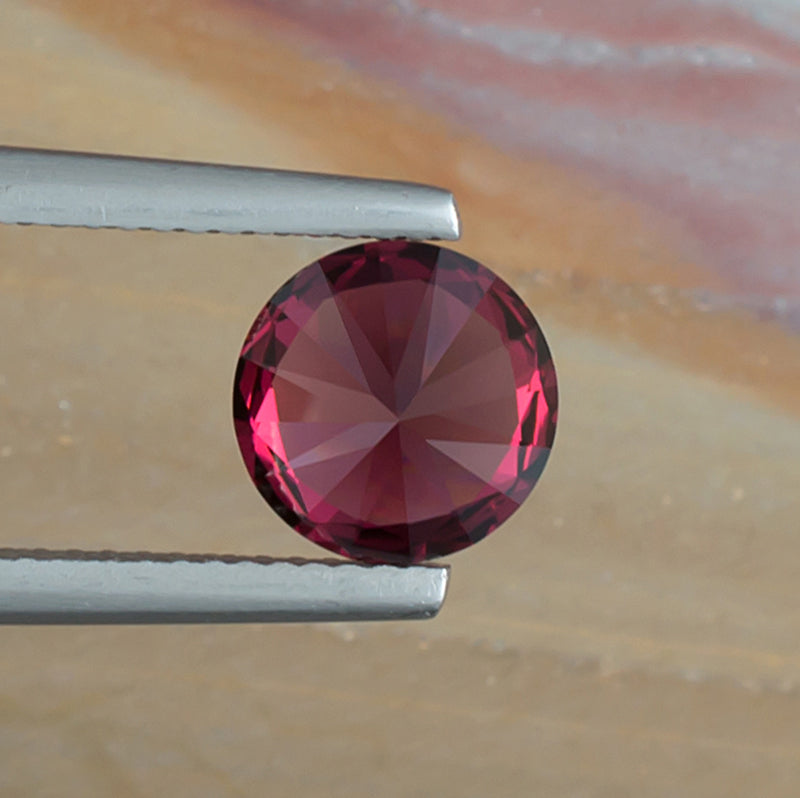 2.46ct Rhodolite Garnet Colored Gemstone Bottom View Natural Background 
