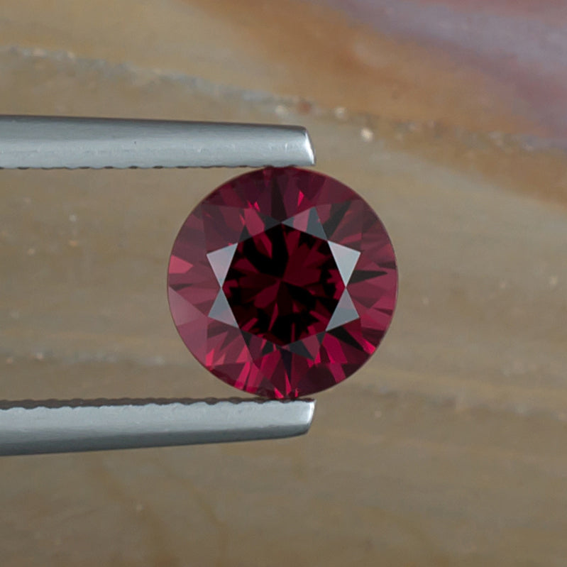 2.46ct Rhodolite Garnet Colored Gemstone Top View Natural Background 
