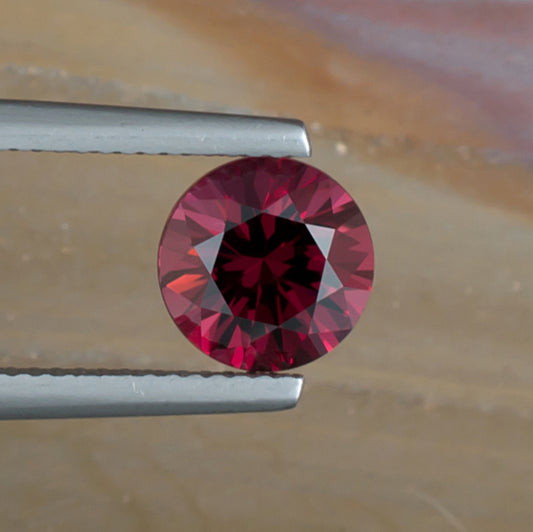 2.46ct Rhodolite Garnet Colored Gemstone Top View Natural Background
