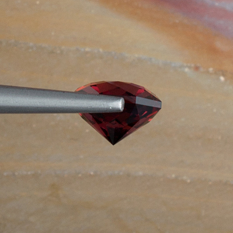 2.52ct Umbalite Garnet Colored Gemstone Side View Natural Background 
