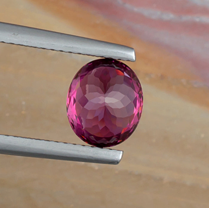 2.65ct Rhodolite Garnet Colored Gemstone Bottom View Natural Background
