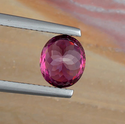 2.65ct Rhodolite Garnet Colored Gemstone Bottom View Natural Background
