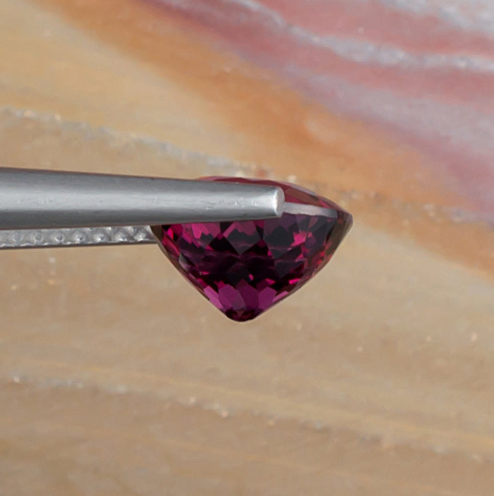 2.65ct Rhodolite Garnet Colored Gemstone Side View Natural Background 
