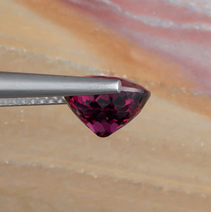 2.65ct Rhodolite Garnet Colored Gemstone Side View Natural Background 
