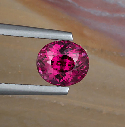 2.65ct Rhodolite Garnet Colored Gemstone Top View II Natural Background 
