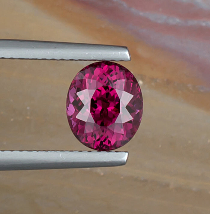2.65ct Rhodolite Garnet Colored Gemstone Top View Natural Background 
