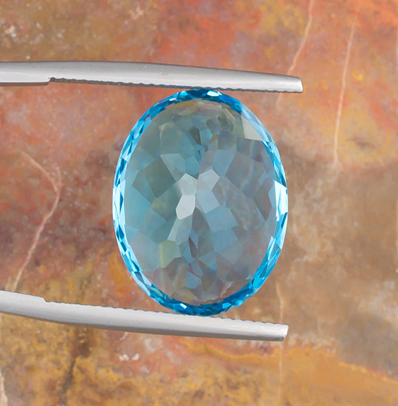22.77ct Blue Topaz Colored Gemstone Bottom View Natural Background 
