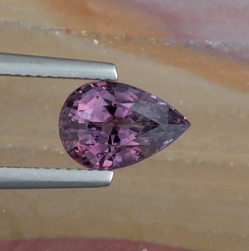 3.19ct Purple Spinel Colored Gemstone Top View Natural Background
