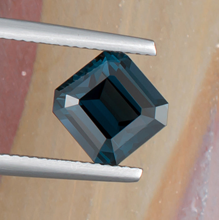 3.55ct Blue Spinel Colored Gemstone Top View Angle Natural Background 
