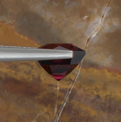3.74ct Mahenge Garnet Colored Gemstone Side View Natural Background 
