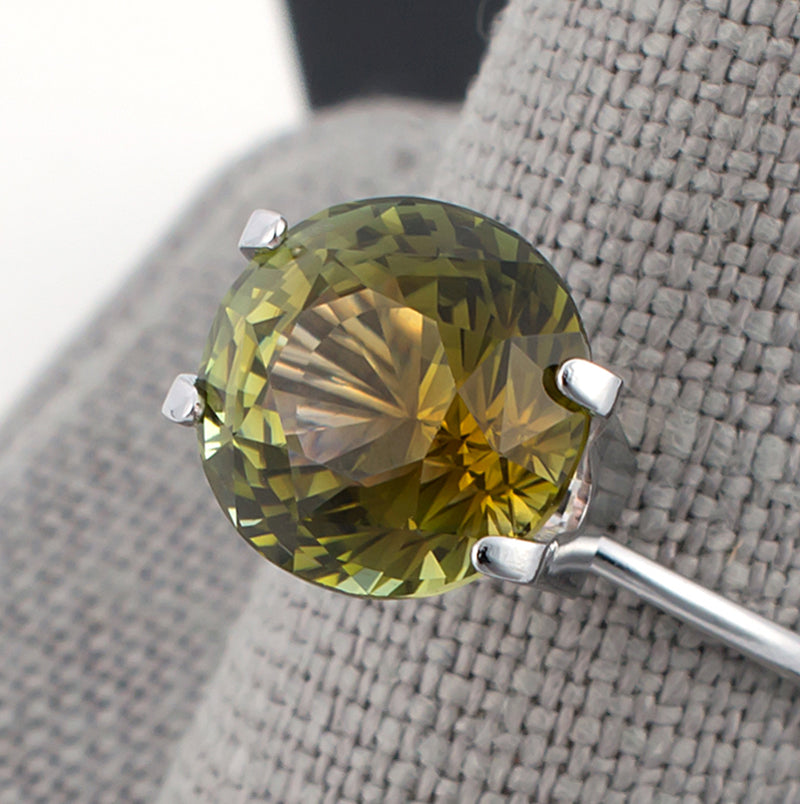 4.97ct Yellow Green Tourmaline Colored Gemstone Top View Grey Finger Background
