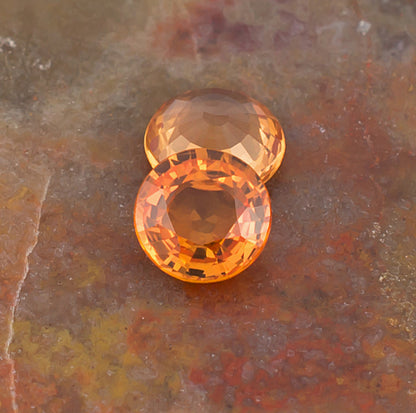 5.00mm Orange Sapphire Colored Gemstone Pair Top View Natural Background
