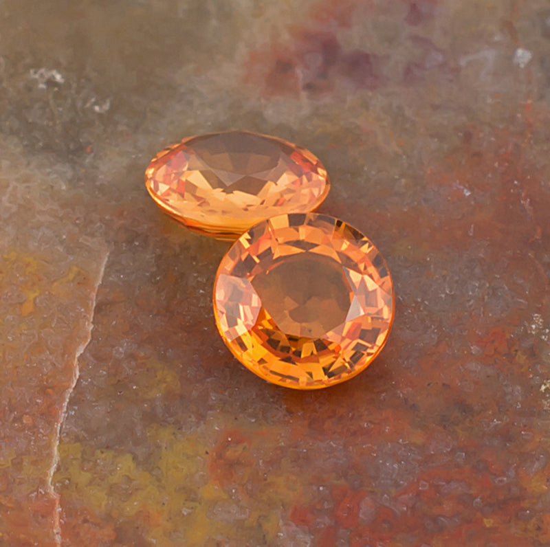 5.00mm Orange Sapphire Colored Gemstone Pair Top View Natural Background
