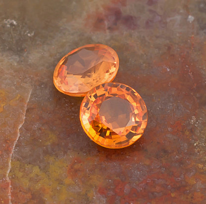 5.00mm Orange Sapphire Colored Gemstone Pair Top View Natural Background
