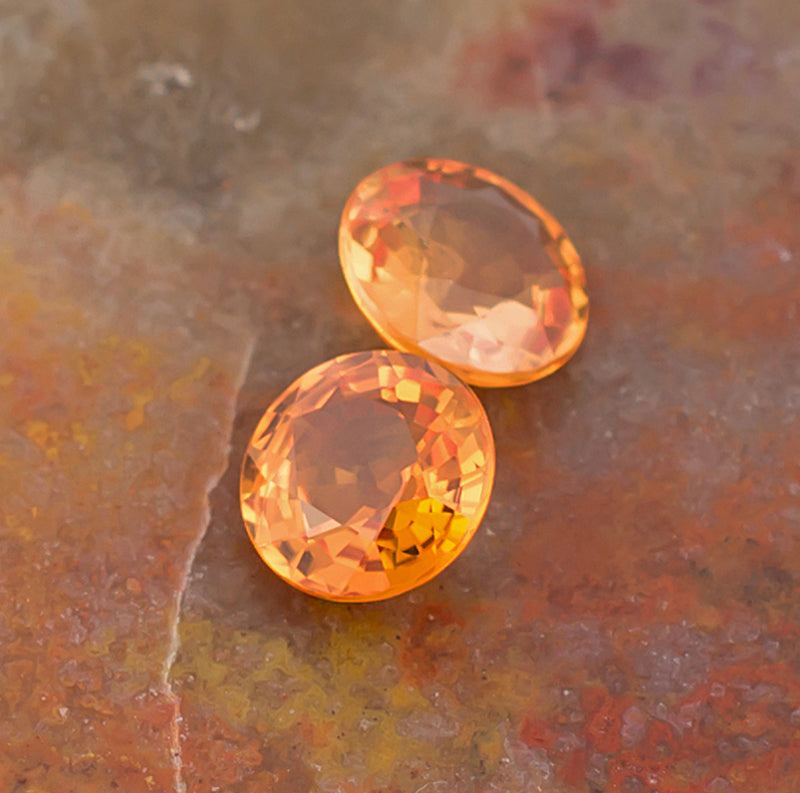 5.00mm Orange Sapphire Colored Gemstone Pair Top View Natural Background
