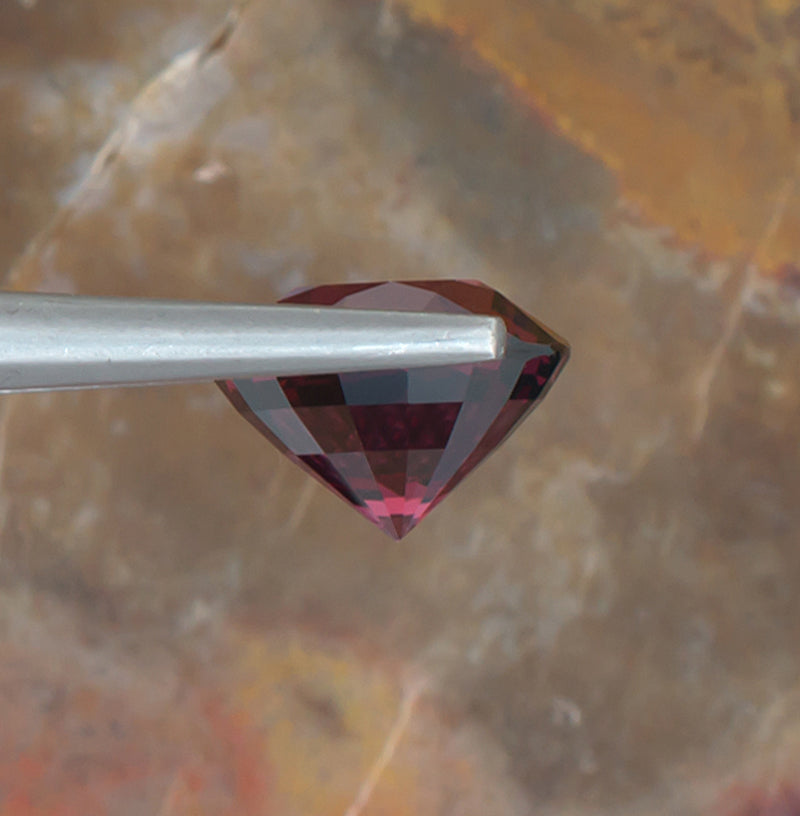 5.28ct Rhodolite Garnet Colored Gemstone Side View Natural Background 