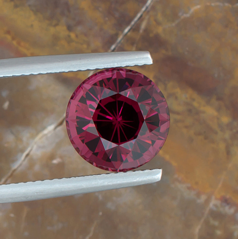 5.28ct Rhodolite Garnet Colored Gemstone Top View Natural Background