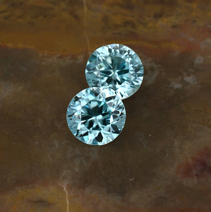 5.30mm Blue Zircon Colored Gemstone Pair Top View Natural Background
