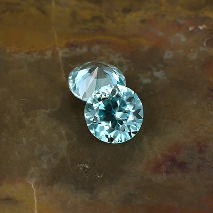 5.30mm Blue Zircon Colored Gemstone Pair Top & Bottom View Natural Background
