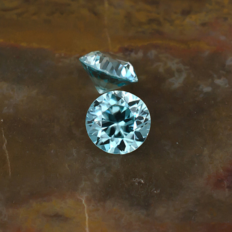 5.30mm Blue Zircon Colored Gemstone Pair Top & Side View Natural Background
