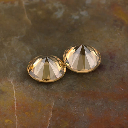 5.50mm Golden Zircon Colored Gemstone Pair Bottom View Natural Background
