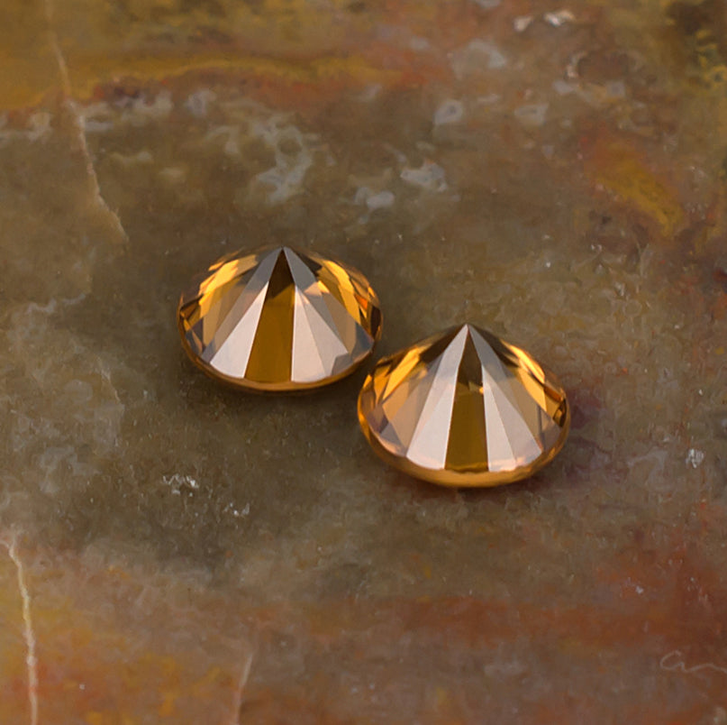 5.50mm Orange Zircon Colored Gemstone Pair Bottom View Natural Background
