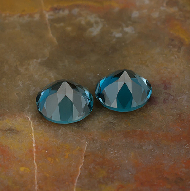 6.00mm Blue Topaz Colored Gemstone Pair Bottom View Natural Background
