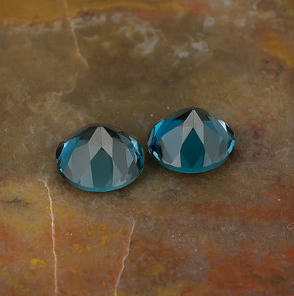 6.00mm Blue Topaz Colored Gemstone Pair Bottom View Natural Background
