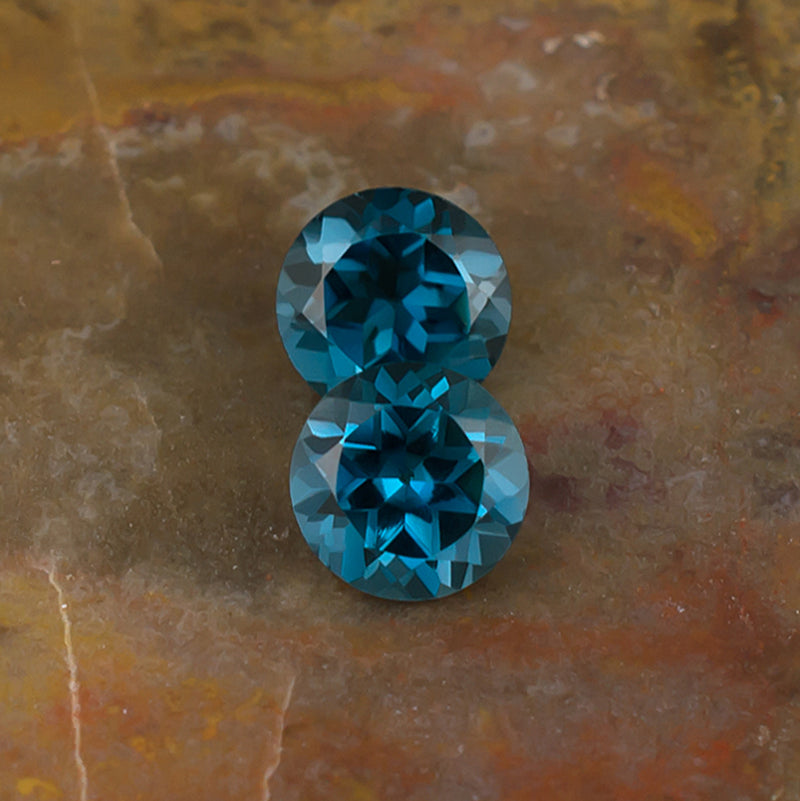 6.00mm Blue Topaz Colored Gemstone Pair Top View Natural Background 
