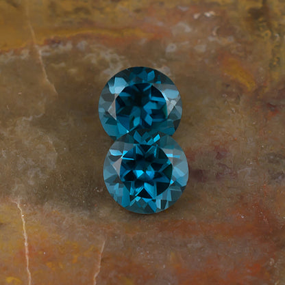 6.00mm Blue Topaz Colored Gemstone Pair Top View Natural Background 
