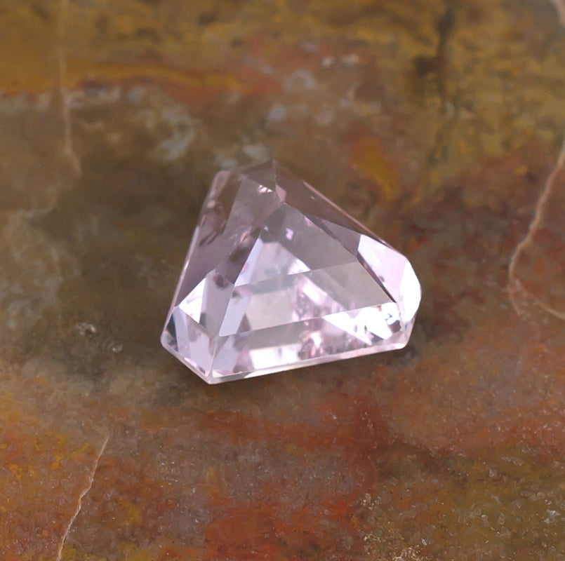 6.57ct Kunzite Colored Gemstone Bottom View Natural Background
