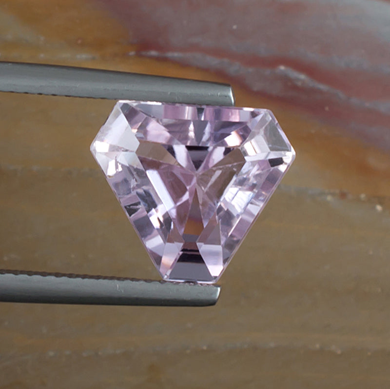 6.57ct Kunzite Colored Gemstone Top View Natural Background 
