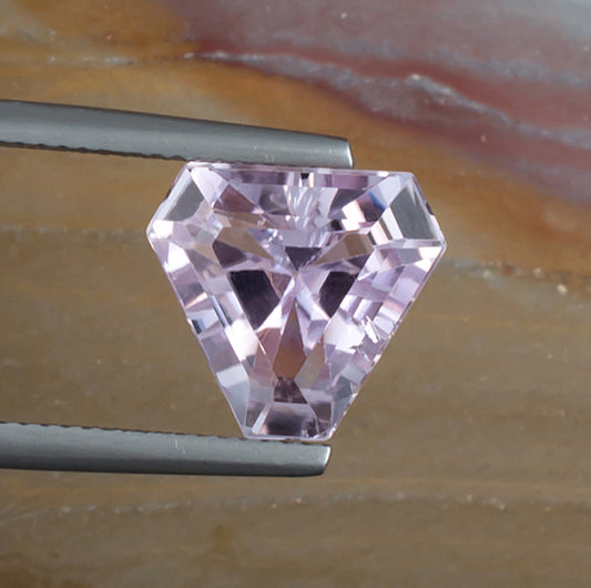 6.57ct Kunzite Colored Gemstone Top View Natural Background 

