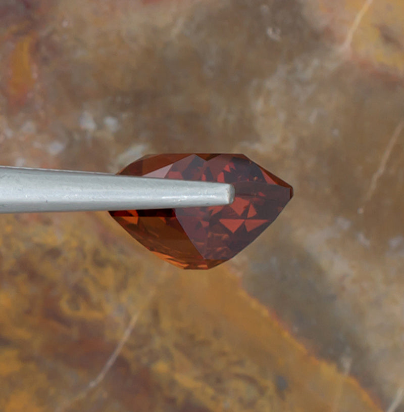 7.15ct Spessartite Garnet Colored Gemstone Side View Natural Background 