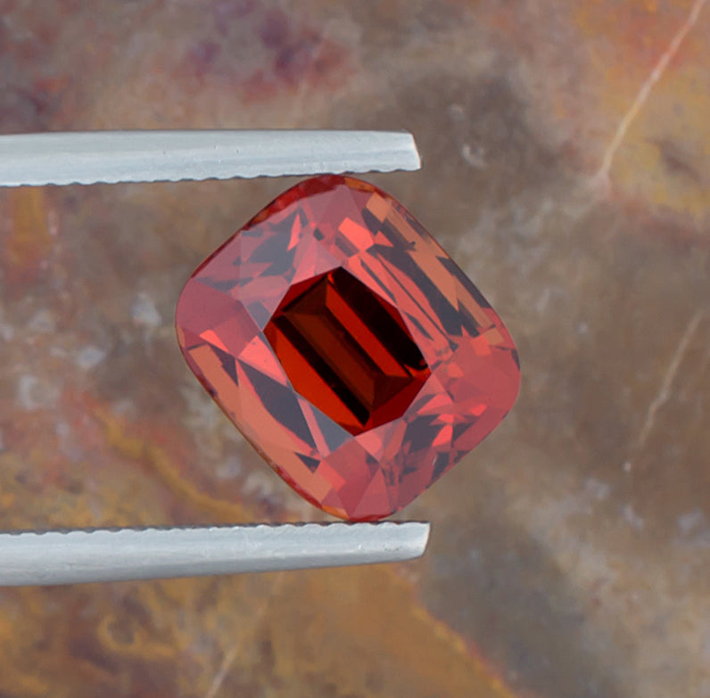 7.15ct Spessartite Garnet Colored Gemstone Top View Angle Natural Background 