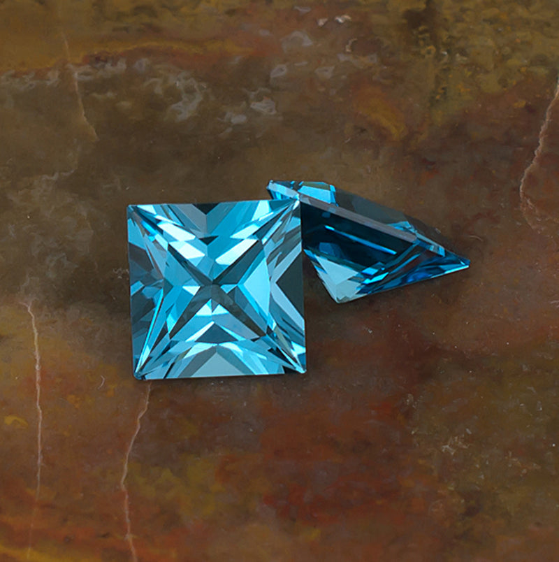 8mm Blue Topaz Colored Gemstone Pair Top Side View Natural Background
