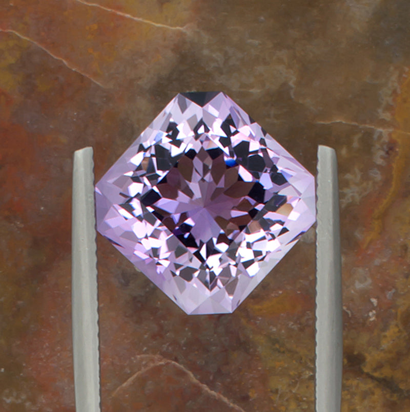 9.73ct Amethyst Colored Gemstone Top View Angle Natural Background 
