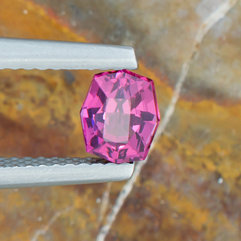 0.92ct Rhodolite Garnet Colored Gemstone Top View Natural Background