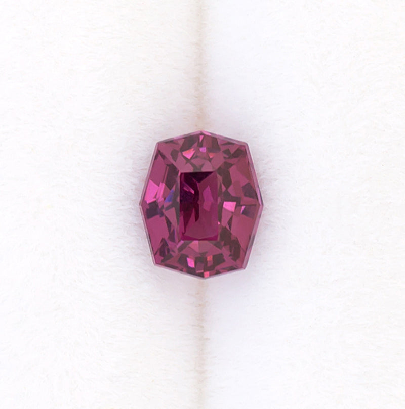 0.92ct Rhodolite Garnet Colored Gemstone Top View White Background Turned